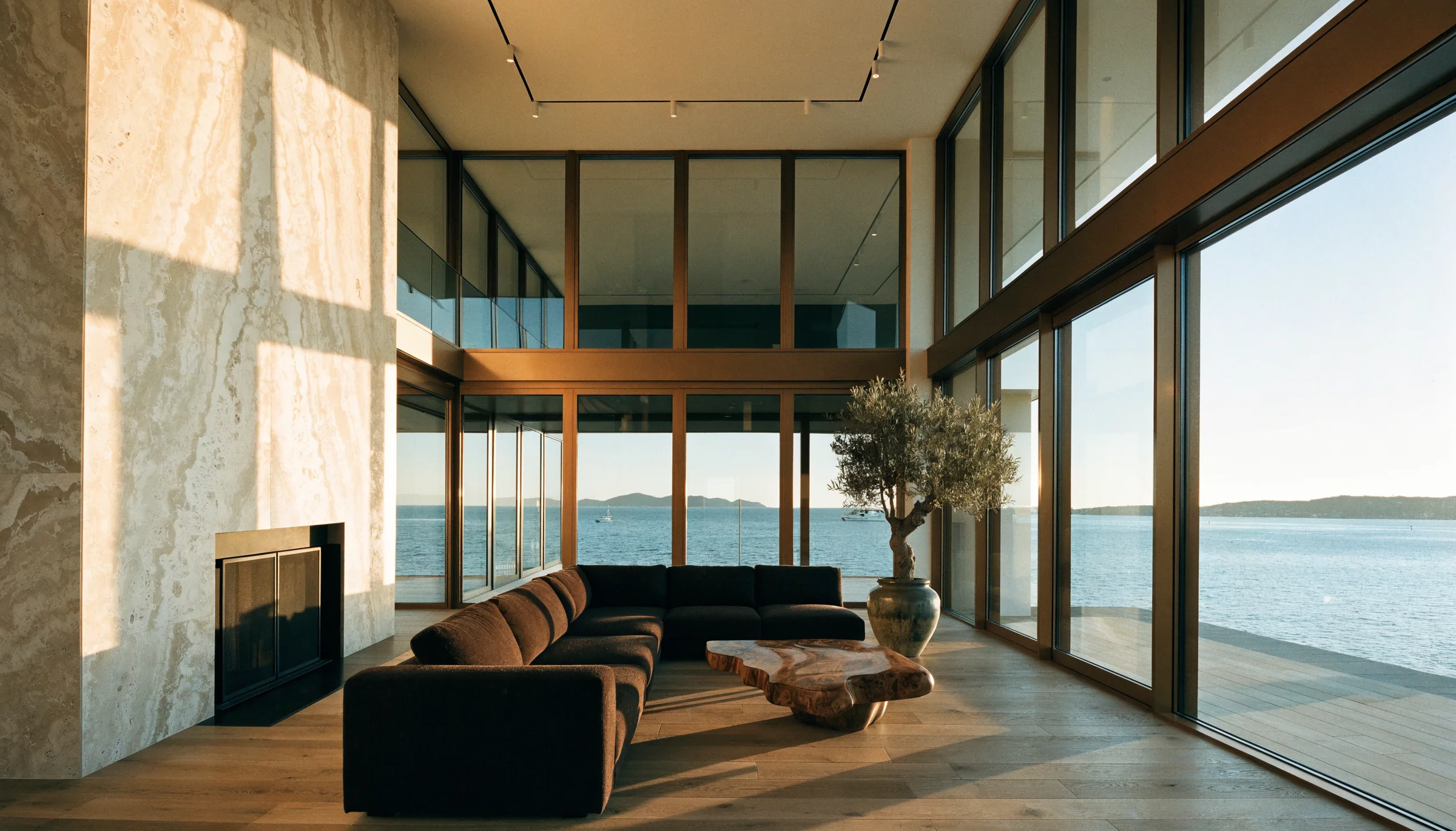 Coastal living room with floor-to-ceiling windows overlooking water